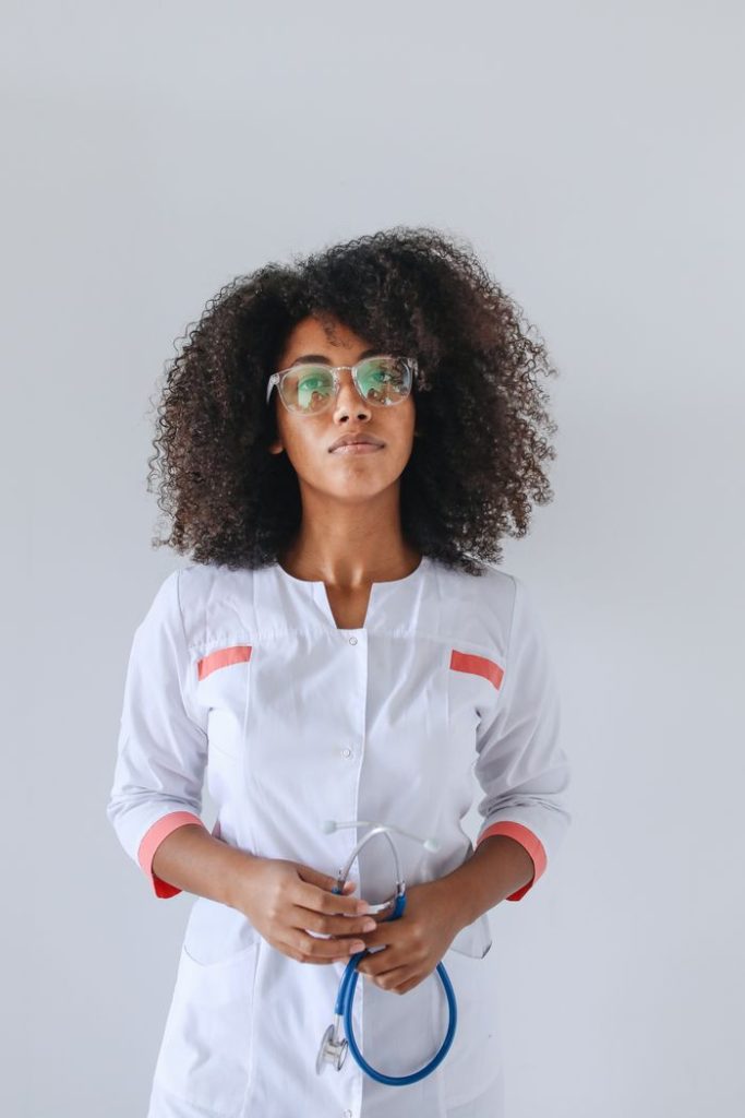 pexels photo 5234463 Portrait of a female doctor wearing glasses and holding a stethoscope indoors.